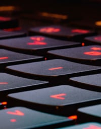 Membrane keyboard keys with red letters viewed closely from an angle