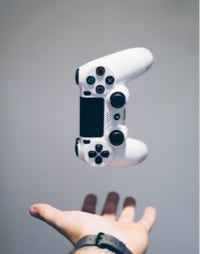 Hand of a guy and a gamepad in midair